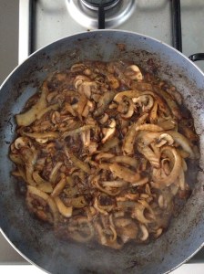 Stout and onion cooking in a frying pan.